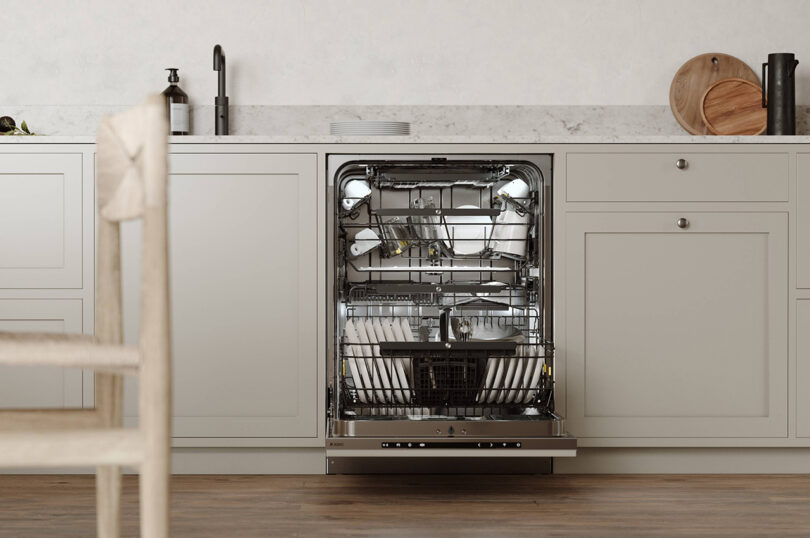 Open dishwasher with clean dishes in a modern kitchen.